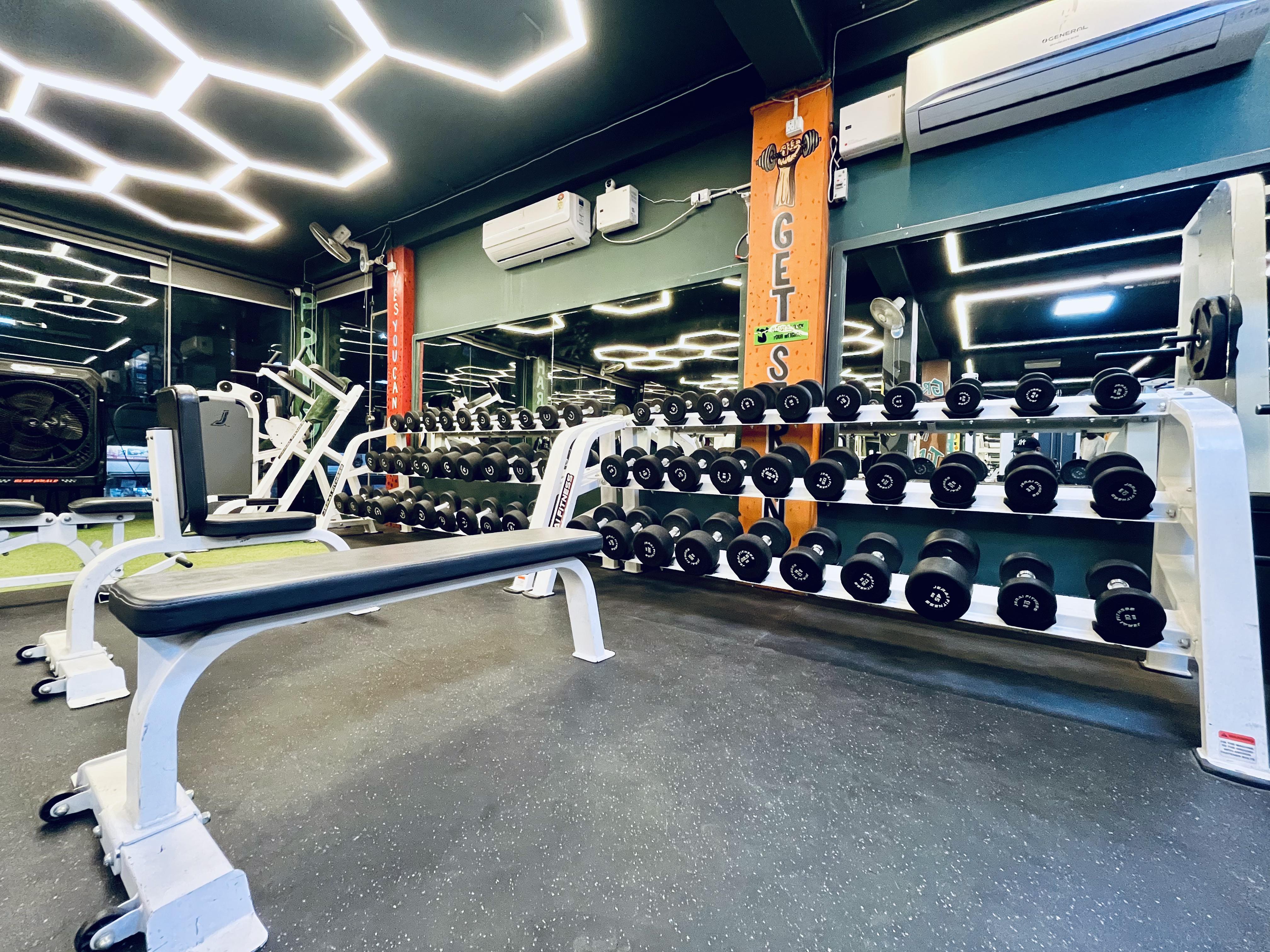 Dumbbell rack at Hulk Fitness with mirror wall